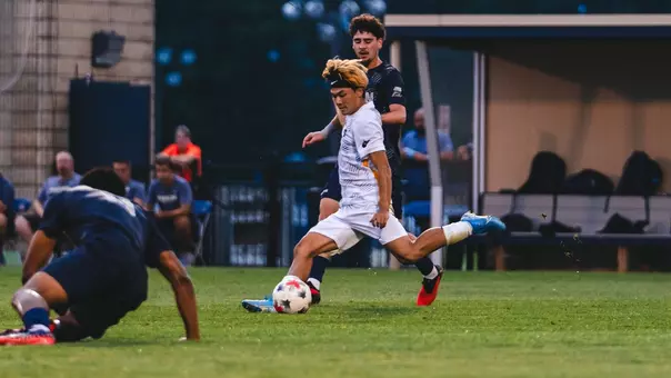 Kanta Ishii kicks the ball against Akron