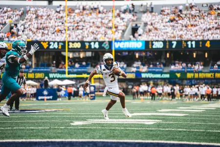 Quarterback Michael Hawkins Jr. (3) scores his first career rushing touchdown as a Mountaineer in the fourth quarter against Coastal Carolina on Sept. 5, 2026.