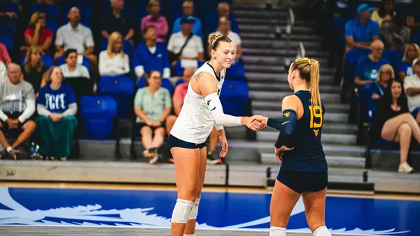 Nina Horning and Reagan Turk shake hands after winning a point against FGCU