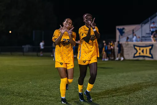 Members of the WVU women's soccer team celebrate a win on Sept. 6.