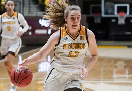 Dec 05, 2020; Laramie, WY, USA; Wyoming Cowgirls guard McKinley Bradshaw (12) drives against the Denver Pioneers at Arena-Auditorium. The Cowgirls beat the Pioneers 79-67. Mandatory Credit: Troy Babbitt-UW Media-Athletics