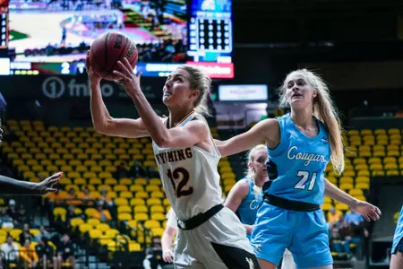 Oct 28, 2022; Laramie, WY, USA; Wyoming Cowgirls guard Malene Pedersen (12) shoots against the Colorado Christian Cougars at Arena-Auditorium. Mandatory Credit: Troy Babbitt-UW Media-Athletics