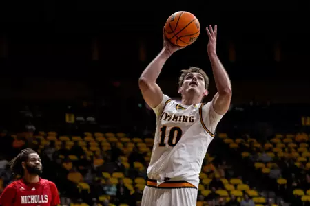 Nov 10, 2022; Laramie, WY, USA; Wyoming Cowboys forward Hunter Thompson (10) shoots against the Nicholls State Colonels at Arena-Auditorium. Mandatory Credit: Troy Babbitt-UW Media-Athletics