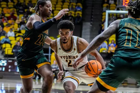 Nov 13, 2022; Laramie, WY, USA; Wyoming Cowboys guard Noah Reynolds (21) against the Southeastern Louisiana Lions at Arena-Auditorium. Mandatory Credit: Troy Babbitt-UW Media-Athletics
