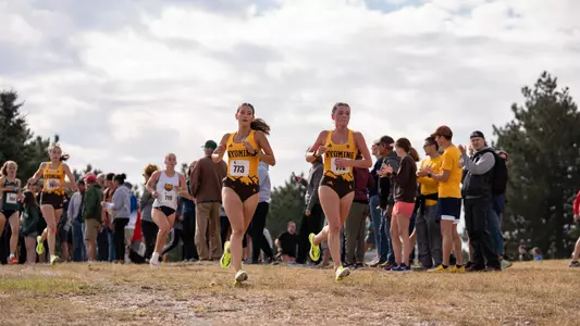 Ella Unrein and Gracie Uhre running at Wyoming Invite
