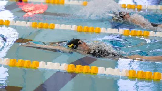 Ava Sims swimming backstroke underwater at Brown vs. Gold