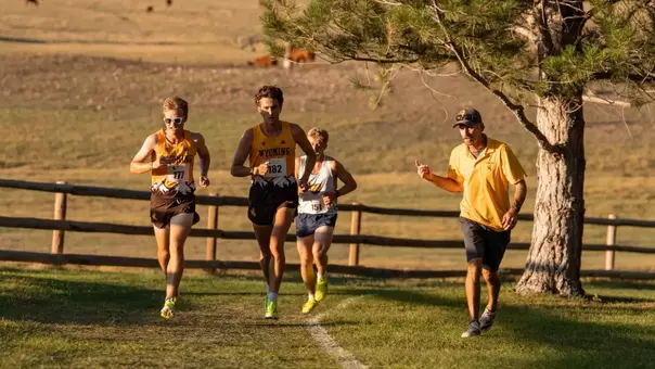 Head Cross Country Coach Scott Dahlberg coaches runners Nolan Hoffman and Guthrie Manzella at Wyoming Invite