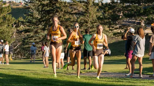 Hailey Uhre, Claire Engelhardt and Muriel Jones running at the Wyoming Invite