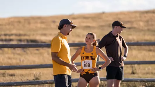 Head Cross Country Coach Scott Dahlberg and Lauren Clarke talking prior to the Wyoming Invite race