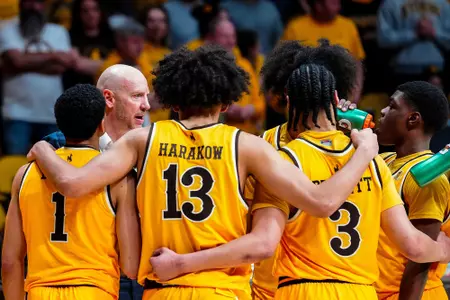 Cowboys huddle during time out against Utah State in 2026