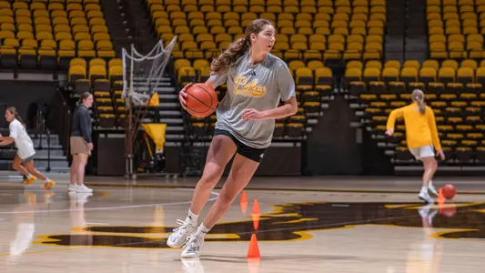 Hayley Johnson dribbles the ball during practice