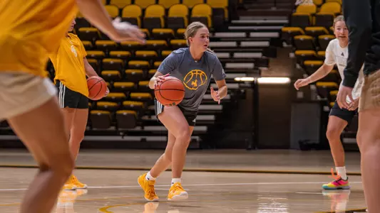 Karly Davis dribbles the ball at a Cowgirl basketball practice