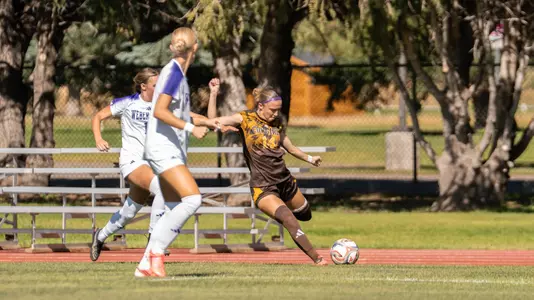 Alyssa Glover crosses one in during a match against Weber State at the Madrid Sports Complex