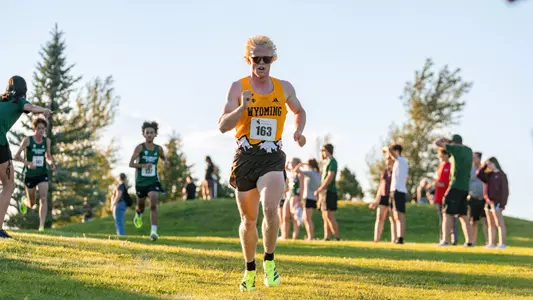 Austin Akers running downhill at the Wyoming Invite