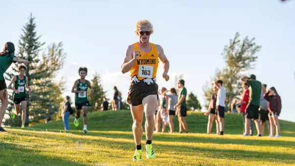 Austin Akers running downhill at the Wyoming Invite