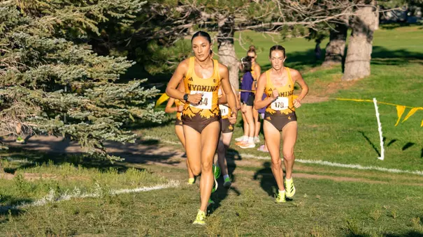 Hanan Aldelemy, followed by Brionna Holso, runs uphill at the Wyoming Invite