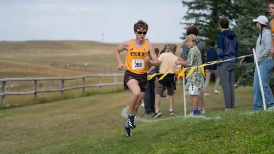 Tanner Brown running uphill at the 2025 Wyoming Invite