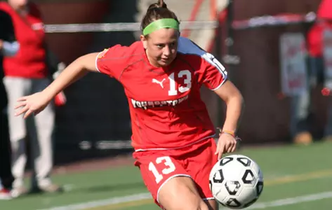 Lauren Brennan kicks a soccer ball