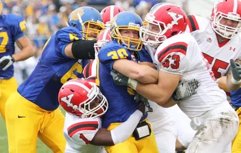 YSU Football team members tackle a SDSU player