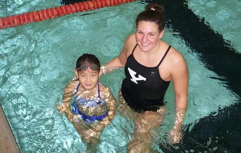 Alana Kane with a young girl in a pool