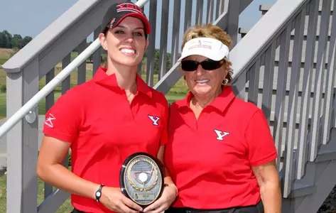 Katie Rogner holds a trophy while standing next to Coach Roseann Schwartz