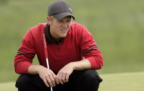 Spencer Sulzener squats to measure a putt