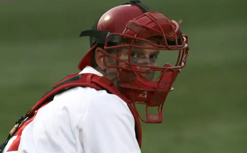 Jonathan Crist looks toward the dugout in his catching position
