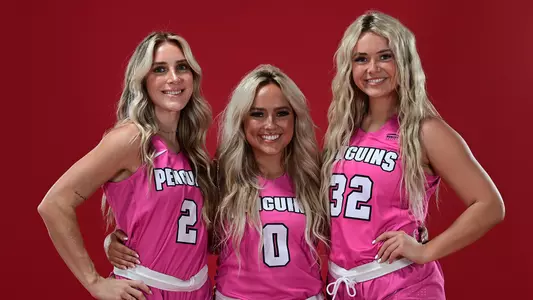 Malia Magestro, Mady Aulbach and Paige Shy wearing pink jerseys to promote the YSU women's basketball team's Pink Game on Feb. 11, 2023
