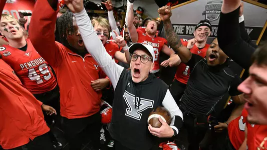 YSU Head Football Coach Doug Phillips and the Penguins celebrate in the locker room following their 41-40 win over North Dakota