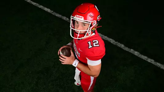 Beau Brungard holding a football in full uniform