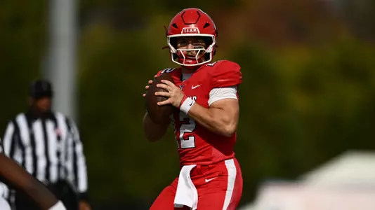 Beau Brungard stands in the pocket holding a football