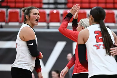 Ava Stratton celebrates a point with Brie Habeeb and Layne Graffice in the Youngstown State volleyball team's match against Kent State on Sept. 19, 2025. Photo by Robert Hayes.