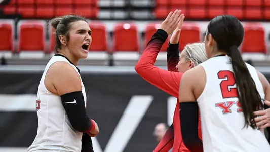 Ava Stratton celebrates a point with Brie Habeeb and Layne Graffice in the Youngstown State volleyball team's match against Kent State on Sept. 19, 2025. Photo by Robert Hayes.