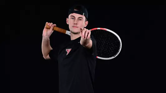 Rafael Le Fur points forward while holding a racquet