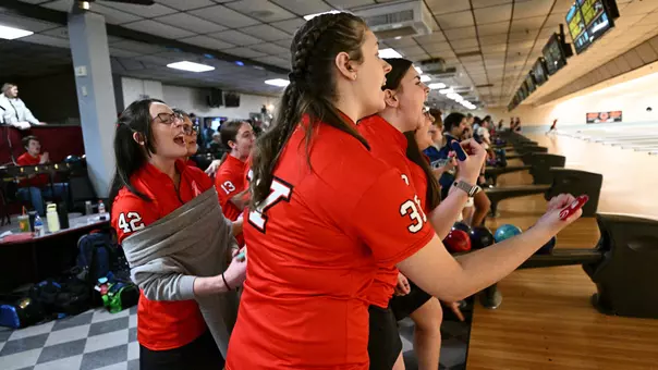 Youngstown State's bowling team, with Gianna Varano in the foreground, cheers on a teammate at the 2026 Chelsea Gilliam Penguin Classic.