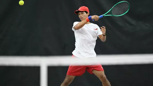 Phopthum Sriwong returns a forehead tennis shot