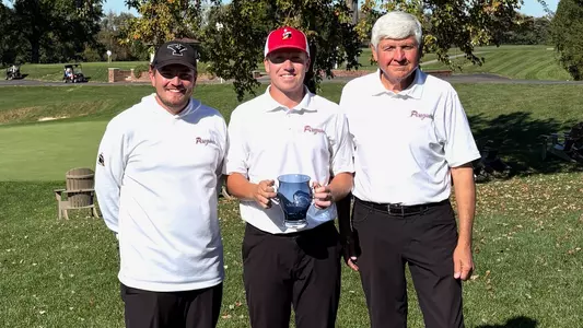 YSU's Ryan Sam poses for a photo with Head Coach Tony Joy and Assistant Coach Brian Terlesky following his win at the Xavier Invitational on Oct. 20, 2026 (Photo by Xavier Athletics)