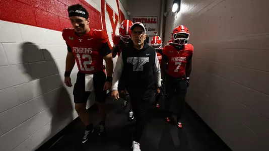 YSU Head Coach Doug Phillips, QB Beau Brungard and RB Jaden Gilbert lead YSU up the tunnel pregame
