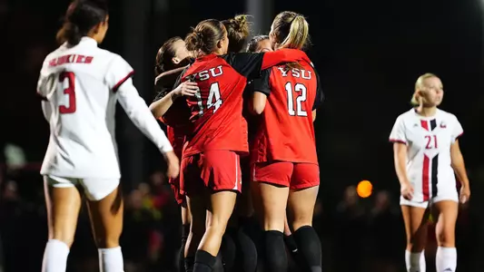 Members of the YSU women's soccer team celebrate together after a goal vs. Northern Illinois