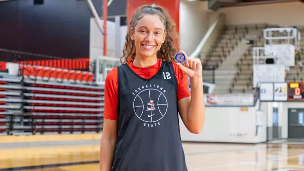 Dacia Lewandowski poses with her jersey patch after being selected as a Kay Yow Servant Leader award winner for the 2026-27 season (Photo by Chloe Whitlock)