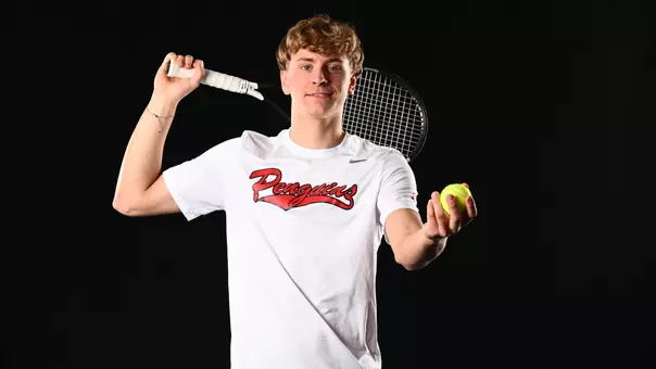 Lenn Stueckrath tosses a tennis ball at media day