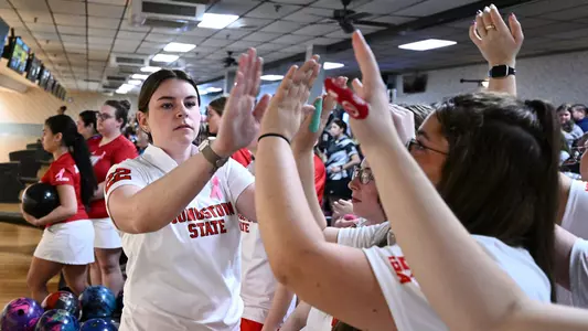 Kara Beissel high-fives her teammates at the Chelsea Gilliam Penguin Classic on Oct. 17, 2026.
