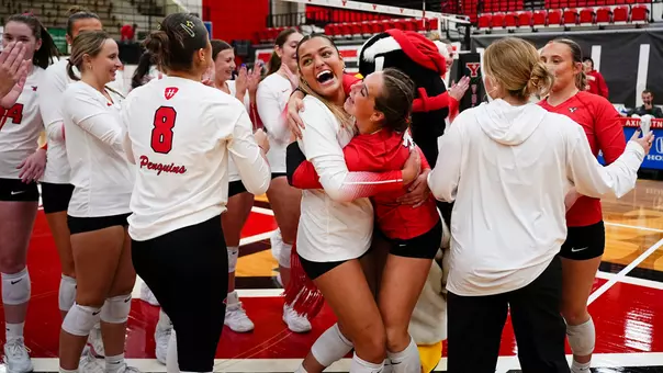 Hayden Rodriguez hugs Journey Nicola as Youngstown State's volleyball team celebrates a 3-0 victory over Robert Morris.