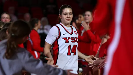 Casey Santoro high fives a youth girls group during starting lineup introductions.