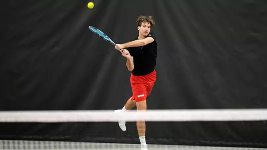Alexis Maulouet returns a tennis shot from the baseline