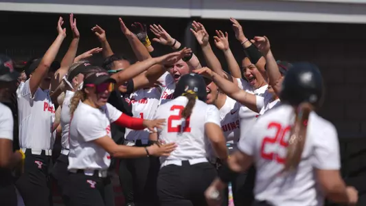The Youngstown State softball team celebrates a home run hit by Lydia Wilkerson against Green Bay