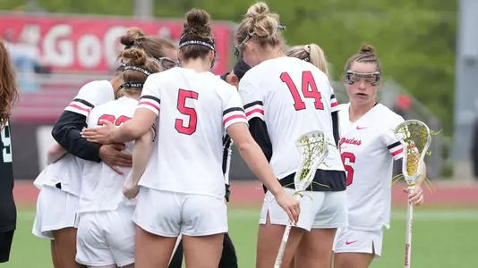 Women' Lacrosse huddles after scoring a goal