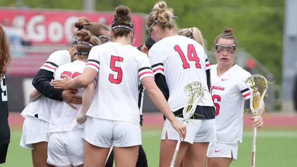 Women' Lacrosse huddles after scoring a goal