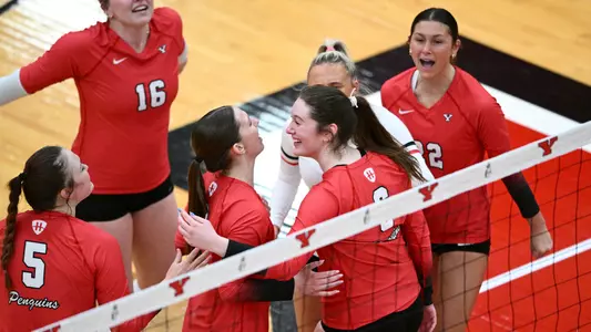 Youngstown State's Ava Prince and Izzy Henry celebrate with their teammates during a volleyball exhibition match vs. Fairmont State on April 10, 20206, inside Zidian Family Arena at Beeghly Center. Photo by Robert Hayes.