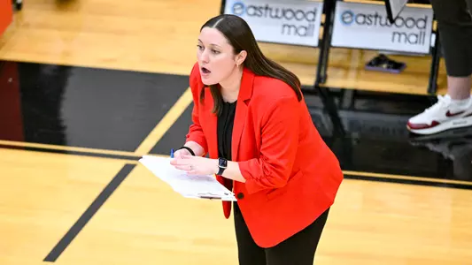 Riley Jarrett holds a clipboard and instructs her team from the sideline during a YSU Volleyball match against Kent State on Sept. 20, 2024, inside Zidian Famil Arena at Beeghly Center.